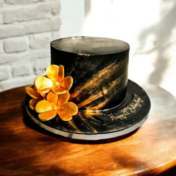Black Cake with gold accents and flowers