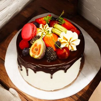 Chocolate Drip Cake with fruits and cookie decorations