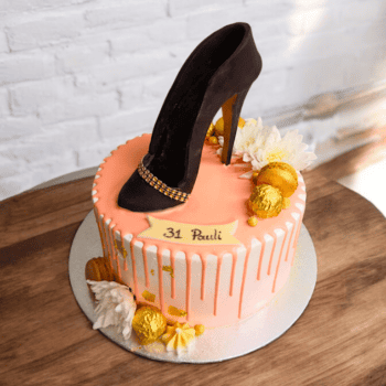 Cake with a high heel, pink chocolate drip and fruits
