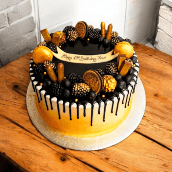 Gold and black Drip Cake with chocolate and cookie decoration