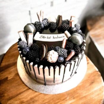 Silver and black Drip Cake with chocolate and cookie decoration