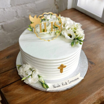 Elegant holy communion cake with fresh flowers