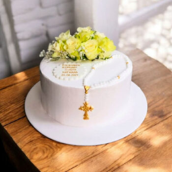 Elegant holy communion cake with fresh flowers and rosary